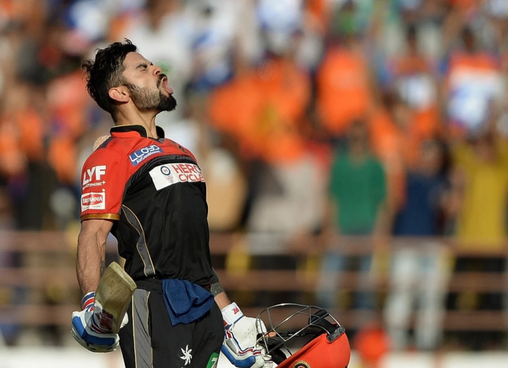 Virat Kohli is animated in celebration after reaching his century off the last ball of the innings