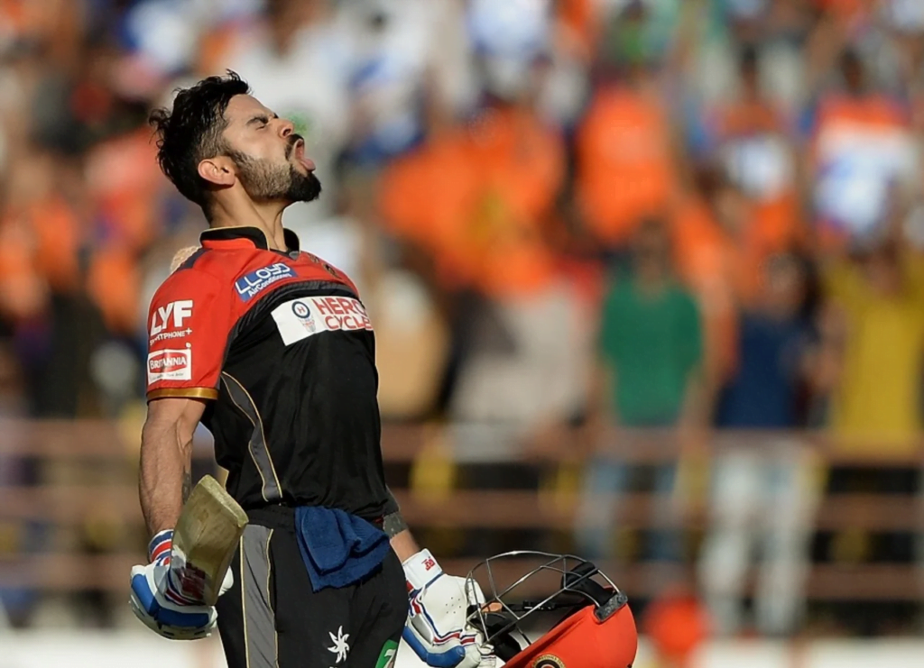 Virat Kohli is animated in celebration after reaching his century off the last ball of the innings